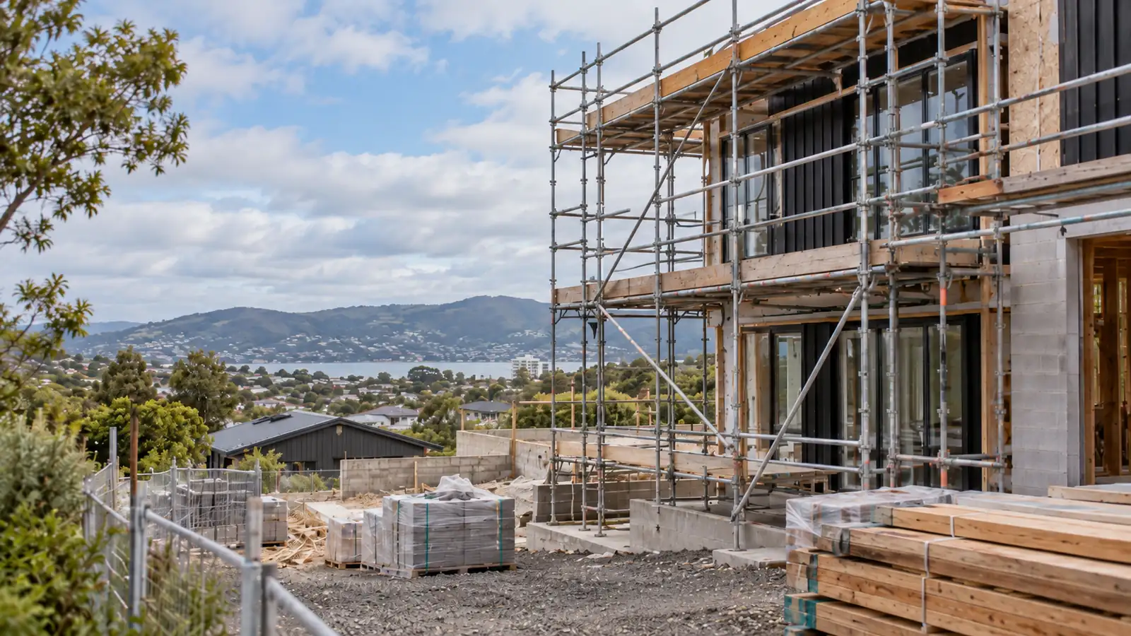 Multi-storey residential development under scaffolding overlooking the harbour
